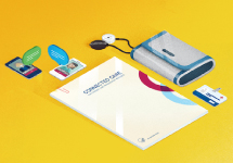 two mobile phones next to connected care brochure and medical devices