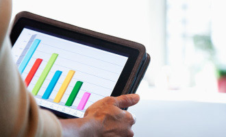 person holding tablet with graph on it