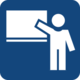 Square button with cartoon person pointing to a classroom board