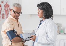 Doctor taking patient's blood pressure