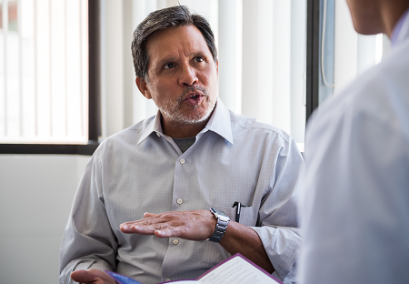 man sitting and talking 