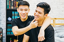 Two young men embracing