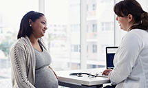 doctor speaking with pregnant patient