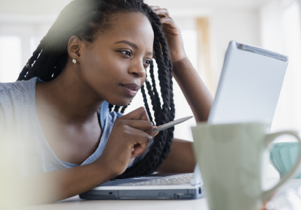 African American woman looking at a computer