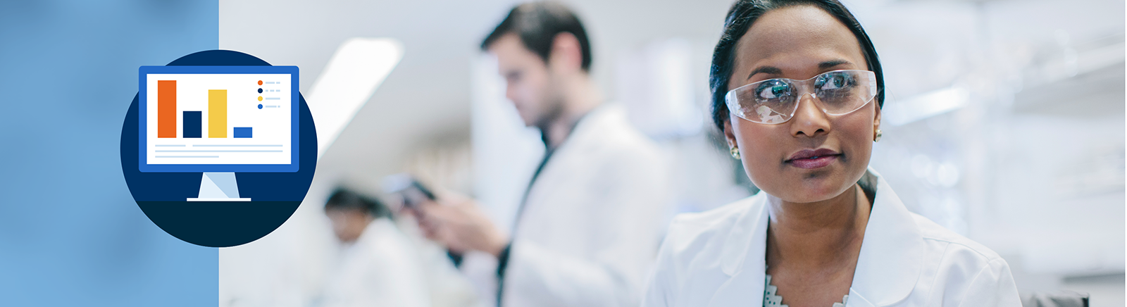 Medical staff in a lab with focus on a minority woman wearing safety glasses