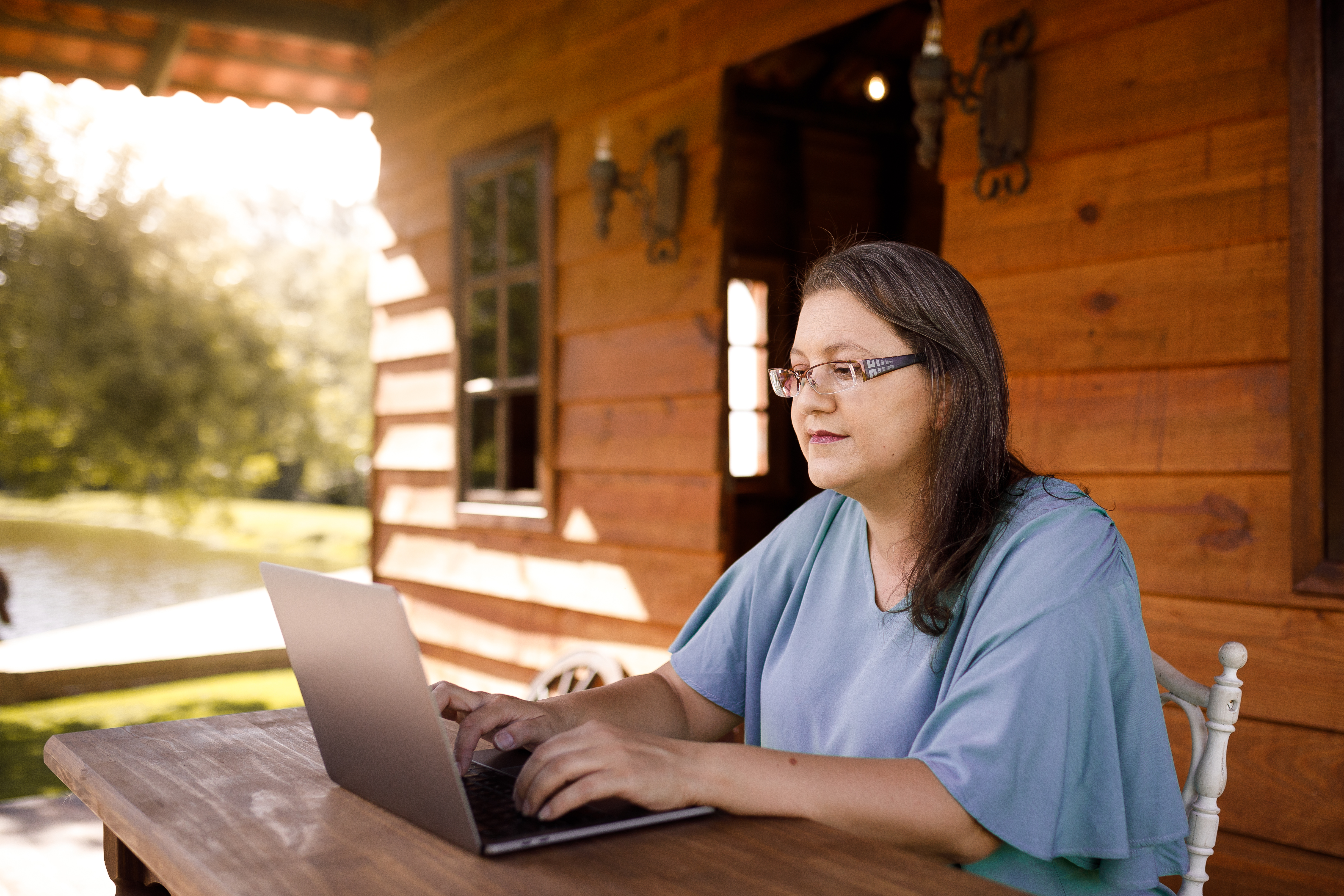 Woman sitting outside using laptop computer 