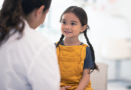A young girl talking to a medical professional