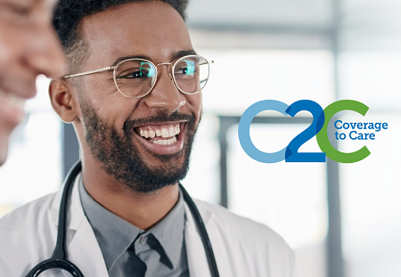 Smiling doctor wearing glasses with stethoscope draped around neck